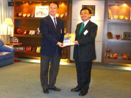 Chairman receiving a  first aid handbook